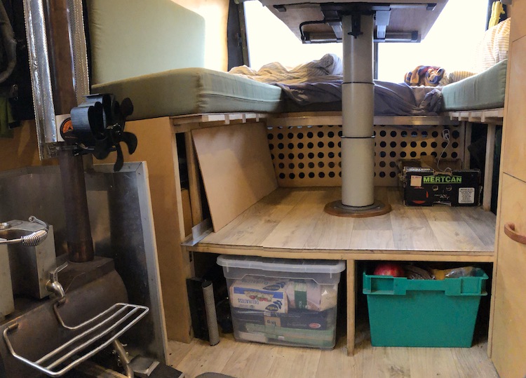 Storage below the table in the center of the van