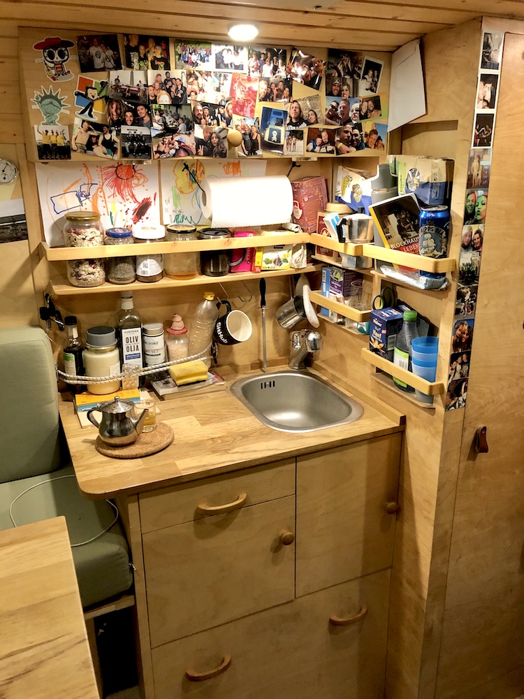 Countertop with a sink, cupboards and shelves