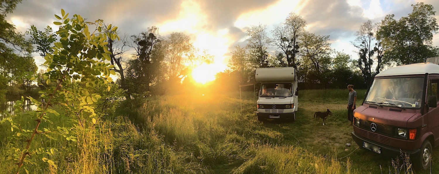 Our vans parked next to a river in France