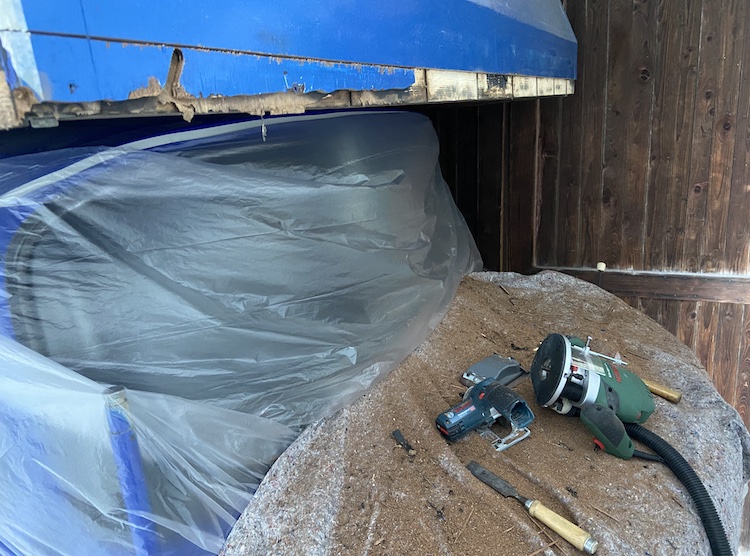 Removing the rotten wood in the front of the cabin