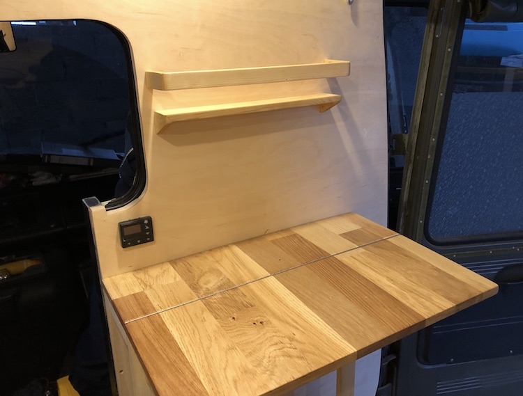 Shelf above the table in the cooking area