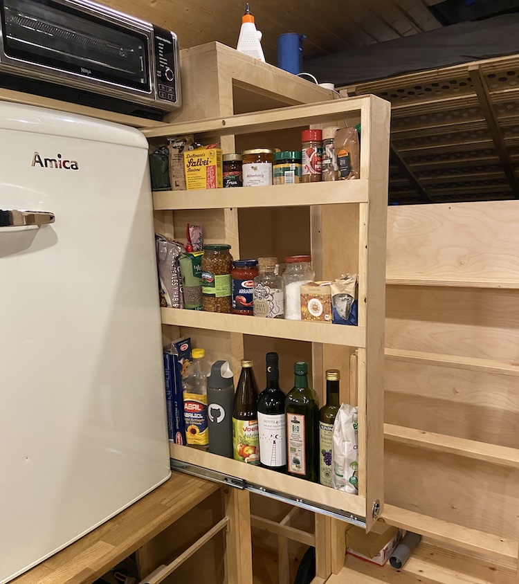 Vertical pull-out cabinet filled with supplies