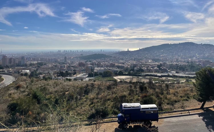 Truck parked outside of Barcelona with a nice view of the city