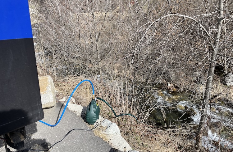 Filling up the water tank with fresh water from the mountain river