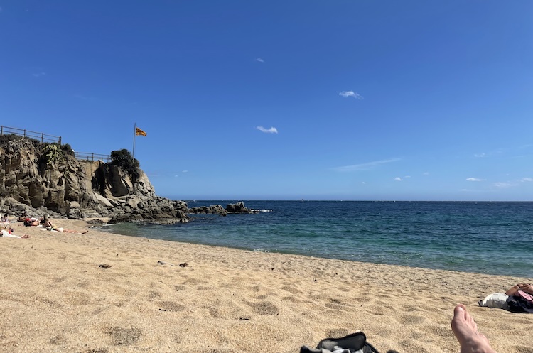 Sun bathing at the beach of Calella de Palafrugell