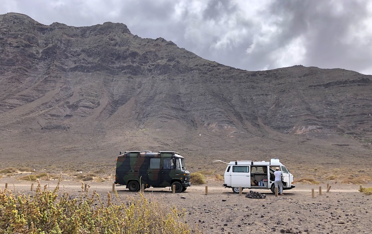 Vans parked in front of the beach