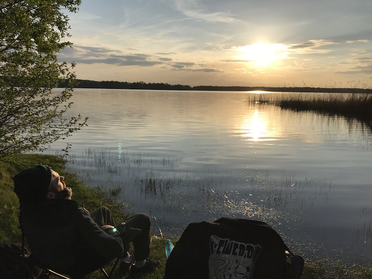 Relaxing and drinking a beer at a lake