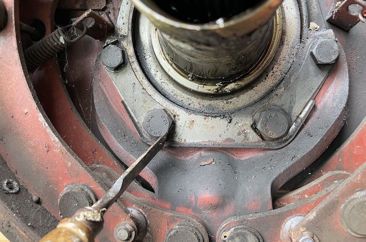 Releasing the locking plate for the bottom bolts holding the brake backing plate