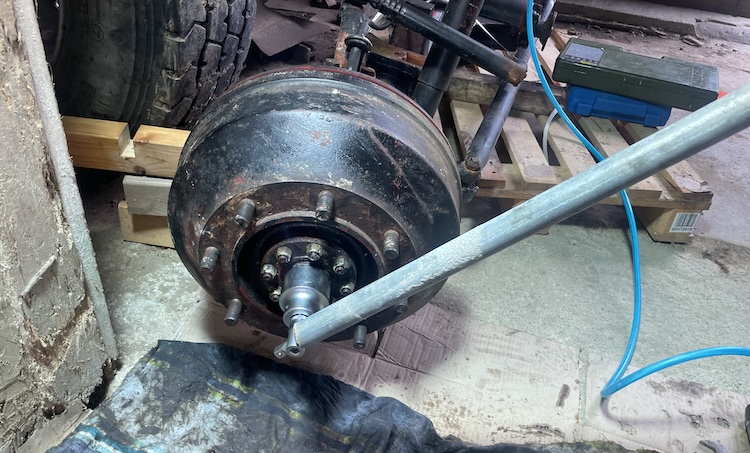 Loosening the large center nut to remove the drive flange