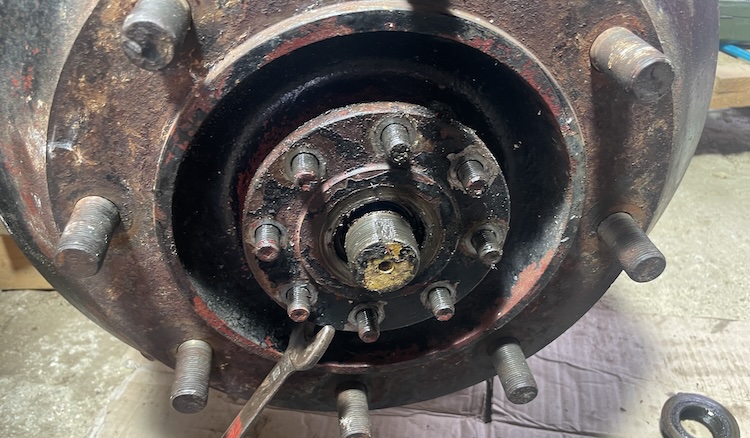 Carefully pulling off the drive flange using a wrench