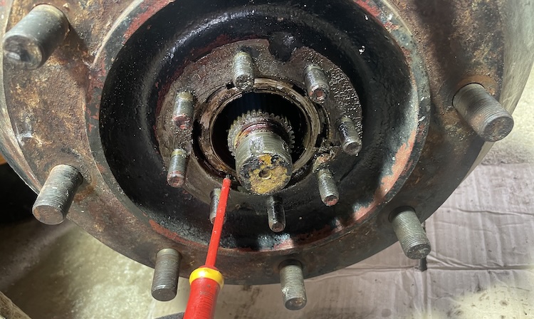 Bending back the lock plate for the outer spindle using a screwdriver