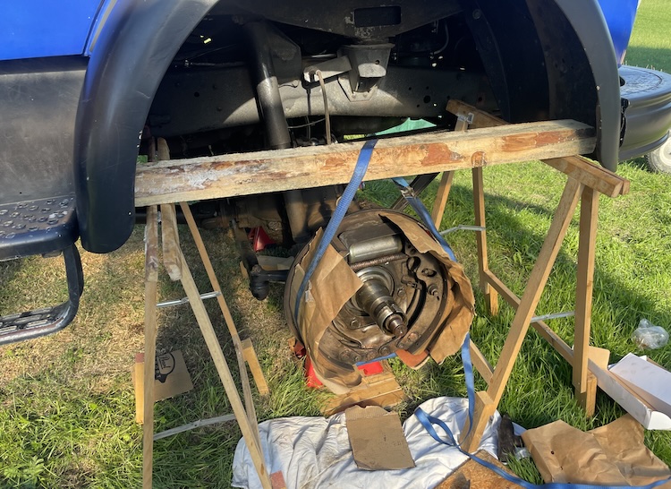 Brake backing plate secured with a ratchet strap