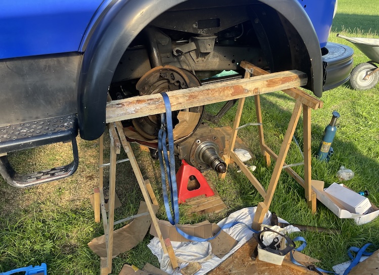 Disassembled brake backing plate lying on the axle