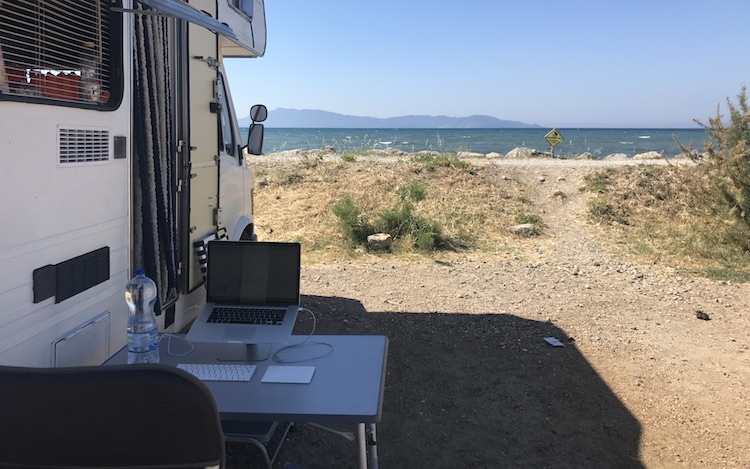 Working outside of the van right next to the sea