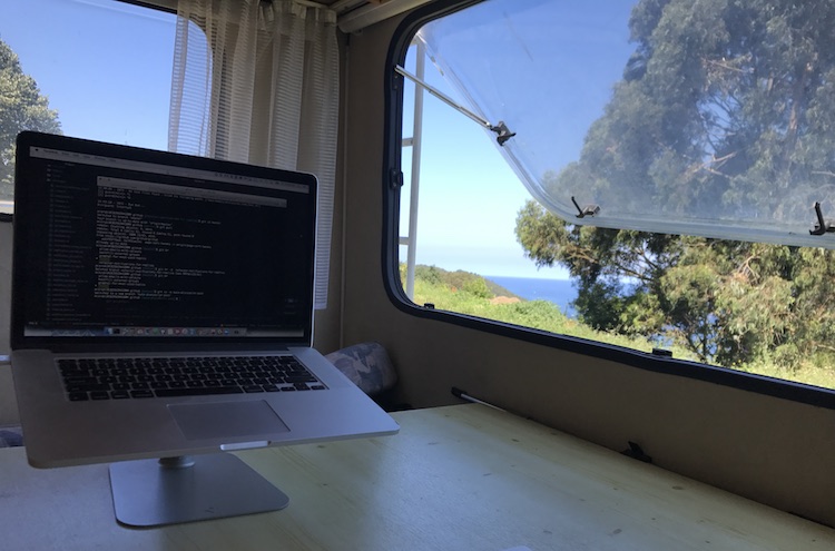 Working in the van right next to the sea