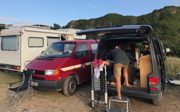 Our vans parked next to a beach