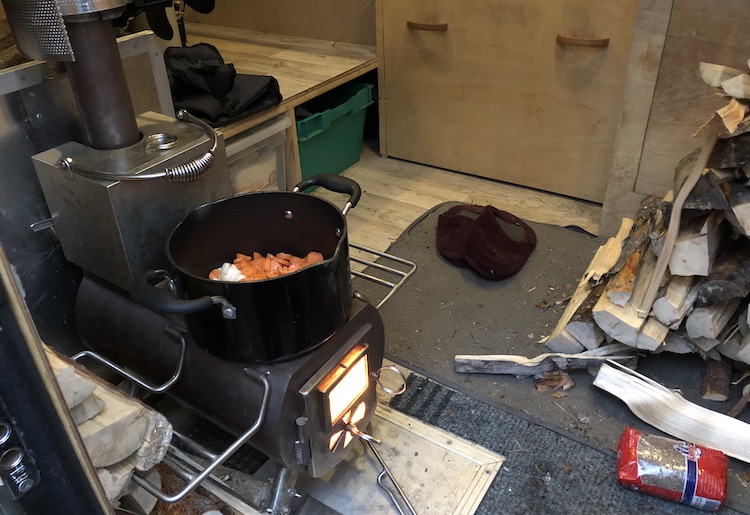 Preparing warm meals on the wood stove