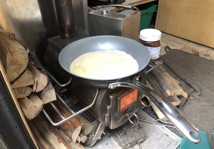 Preparing pancakes on the wood stove
